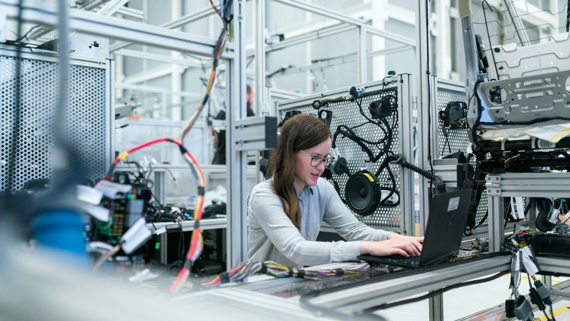 A senior engineer reviews AI-generated code on a screen, comparing it to legacy software engineering principles.